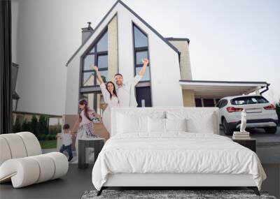 Photo portrait of cheerful big happy family parents laughing greeting spending leisure with little kids brother sister playing outside Wall mural