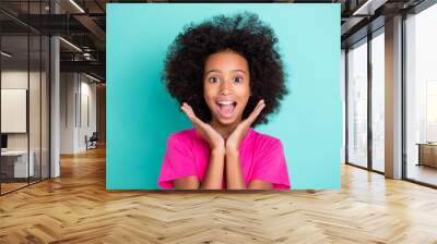 Photo portrait of excited afro american girl screaming with palms near face isolated on vivid cyan colored background Wall mural