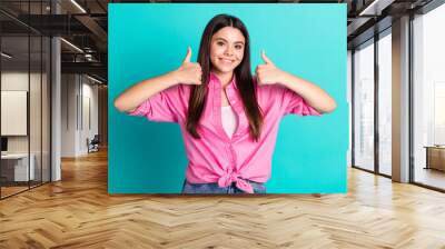 Photo portrait of lovely teen lady thumb up approve dressed stylish pink garment isolated on cyan color background Wall mural