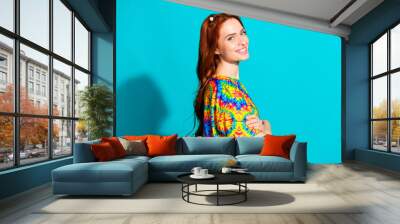 Photo portrait of lovely young lady profile crossed hands confident dressed stylish colorful garment isolated on cyan color background Wall mural