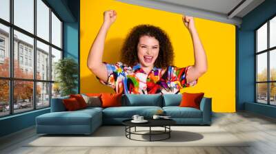 Photo portrait of lovely young lady winning celebrate dressed stylish colorful print garment isolated on yellow color background Wall mural