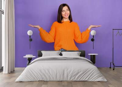 Photo portrait of lovely young woman hands scales look empty space wear trendy knitwear orange outfit isolated on violet color background Wall mural