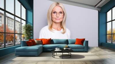 Photo portrait of old woman in glasses isolated on grey colored background with blank space Wall mural