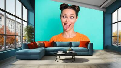 Photo portrait of pretty girl grimacing fooling showing tongue with girlish hairstyle isolated bright turquoise color background Wall mural