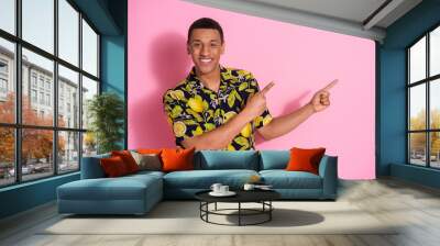 Photo portrait of pretty young male point empty space wear trendy tropical print outfit isolated on pink color background Wall mural