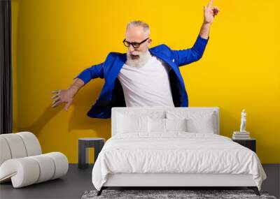 Photo portrait of senior man in blue suit dancing at party isolated bright yellow color background Wall mural