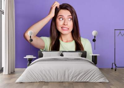 Photo portrait of unsure doubted girl stressed looking at blank space isolated on vibrant purple color background Wall mural