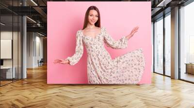 Photo portrait smiling girl throwing floral dress isolated pastel pink color background Wall mural