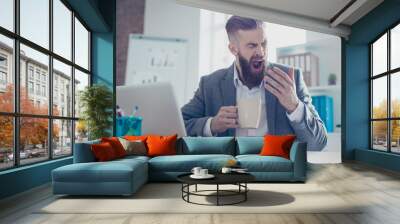 Portrait of a sleepy tired businessman snoozing and having a coffee at the work place Wall mural