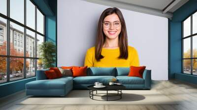 Portrait of attractive cheerful content girl wearing specs yellow sweater isolated over grey color background Wall mural