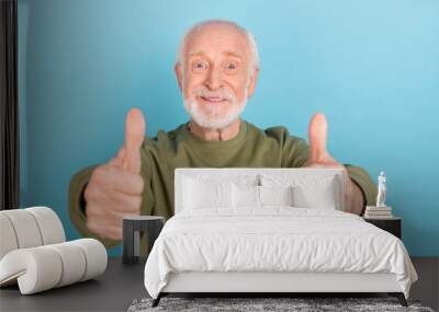 Portrait of attractive cheerful funny grey-haired man giving two thumbup ad isolated over bright blue color background Wall mural