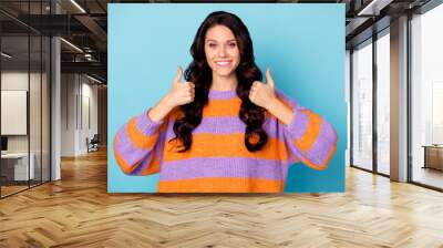 Portrait of attractive cheerful wavy-haired girl showing double thumbup ad advert isolated over bright blue color background Wall mural