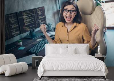 Portrait of attractive ecstatic cheerful lucky girl having fun developing web project startup at workplace workstation indoors Wall mural