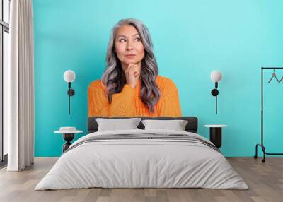 Portrait of attractive grey-haired woman thinking question ask clue guess isolated over bright teal turquoise color background Wall mural