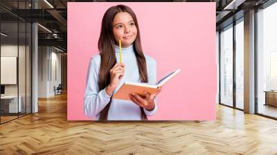 portrait of attractive minded cheery brainy girl writing notes copybook thinking copy space isolated Wall mural