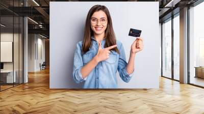 Portrait of attractive positive person direct finger debit card great offer isolated on grey color background Wall mural