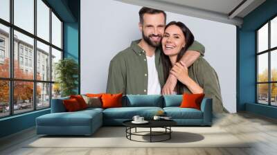 Portrait of attractive tender sweet cheerful couple cuddling romance time enjoying isolated over grey pastel color background Wall mural