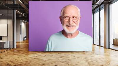 Portrait of beard old man wear light blue t-shirt spectacles look empty space isolated on violet color background Wall mural