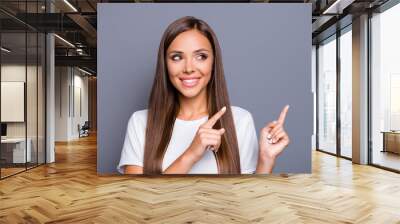 portrait of brown-haired gorgeous attractive nice smiling young lady with logn hair over grey backgr Wall mural