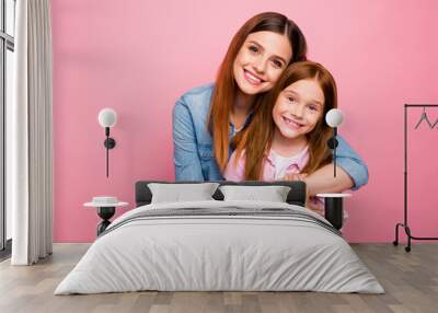 Portrait of charming ladies with long hair cuddling with beaming smile isolated over pink background Wall mural