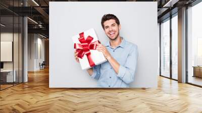 Portrait of cheerful candid lover man hold big wish gift box on valentine day holidays prepare for date with girlfriend wear stylish clothes isolated over grey color background Wall mural