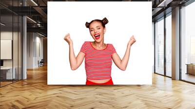 Portrait of cheerful girl with toothy smile raised hands and showing successful celebrate goal isolated on red background Wall mural