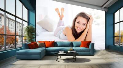 Portrait of cheerful positive girl lying on bed enjoying perfect morning time st home day health healthy good life nap daydreaming Wall mural