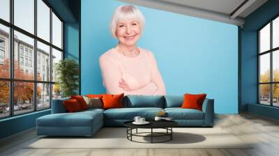 Portrait of cheerful woman looking at camera with her beaming smile isolated over blue background Wall mural