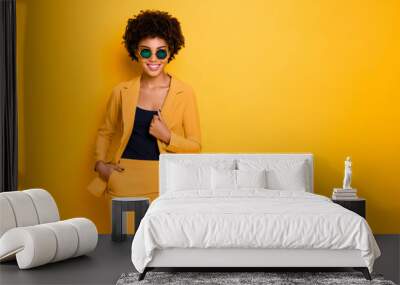 Portrait of confident cool sweet pretty dark skin girl dream feel content expressions wear stylish outfit isolated over yellow color background Wall mural