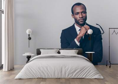 Portrait of confident discerning self-affured chief on a company dressed in black jacket and white shirt holding glasses in hand, isolated on gray background, copy-space Wall mural