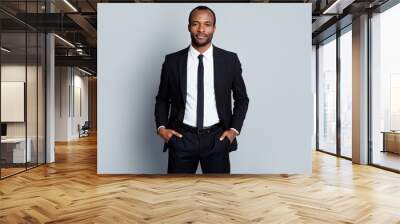 Portrait of confident intelligent afro american man marketer representative put hands pocket pants trousers ready decide successful solutions isolated over gray color background Wall mural