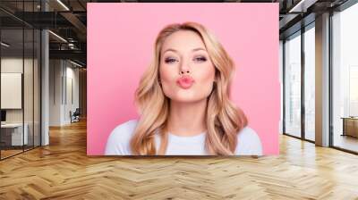 Portrait of cute lovely girl in casual outfit with modern hairdo sending blowing kiss with pout lips looking at camera  isolated on pink background. Affection feelings concept Wall mural