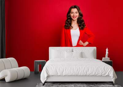 Portrait of elegant lady looking with toothy smile wearing suit isolated over red background Wall mural