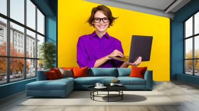 Portrait of gorgeous positive person hold use wireless netbook coworking isolated on yellow color background Wall mural