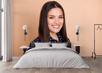 Portrait of half turned satisfied lady toothy smile look camera wear retro dotted isolated on beige color background Wall mural