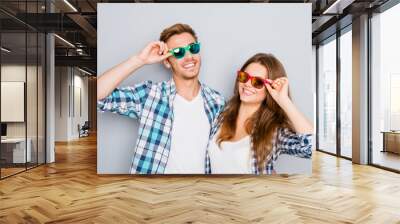 Portrait of happy smiling couple in love wearing colored spectac Wall mural