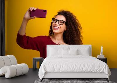 Portrait of her she nice cute attractive cheerful cheery wavy-haired lady holding in hands cell making taking selfie photo capturing isolated on bright vivid shine orange background Wall mural