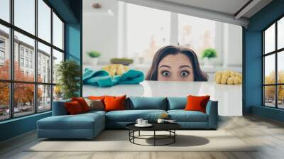 Portrait of her she nice cute lovely beautiful girlish funny shocked wavy-haired house-wife hiding behind shine glossy table in modern light white interior indoors Wall mural