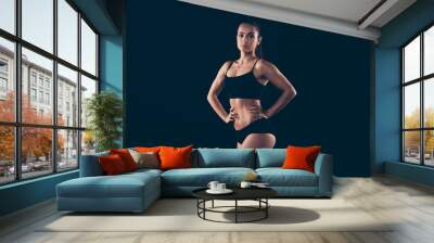 Portrait of her she nice-looking attractive adorable content sportive perfect strong lady fitness bikini model body builder posing pilates isolated over black background Wall mural