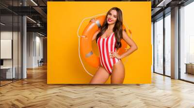 Portrait of her she nice-looking attractive alluring lovable cheerful cheery fit thin slim sporty girl model carrying rope lifesaver isolated on bright vivid shine vibrant yellow color background Wall mural