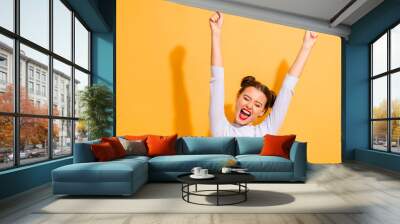 Portrait of her she nice-looking attractive lovely winsome sweet cheerful cheery optimistic girl having fun rejoicing raising hands up party isolated on bright vivid shine yellow background Wall mural