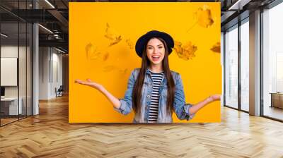 Portrait of her she nice-looking winsome attractive lovely optimistic cheerful cheery straight-haired lady throwing leaves isolated over bright vivid shine yellow background Wall mural