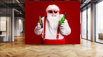 Portrait of his he attractive cheerful cheery funny fat white-haired Santa holding in hand beer bottles invite festal event isolated bright vivid shine vibrant red burgundy maroon color background Wall mural