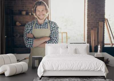 Portrait of his he attractive handsome cheerful cheery guy woodworker furniture building folded arms at industrial brick loft style interior indoors Wall mural