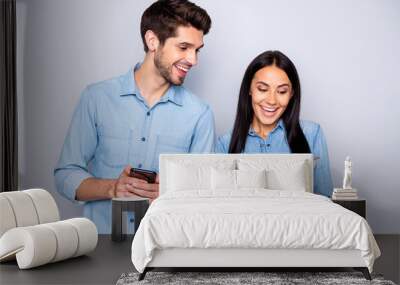 Portrait of his he her she nice attractive charming glad excited cheerful cheery couple holding in hands cell using 5g wi-fi connection speed isolated over light white gray pastel color background Wall mural