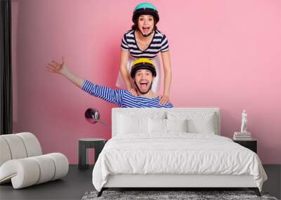 Portrait of his he her she nice attractive cheerful cheery crazy childish humorous careless couple guy driving moped girl standing having fun fooling isolated on pink pastel color background Wall mural