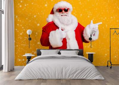 Portrait of his he nice attractive cheerful confident fat Santa demonstrating copy empty blank place space way direction choose choice isolated over bright vivid shine vibrant yellow color background Wall mural