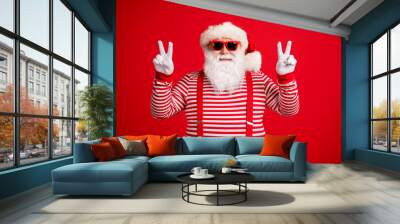 Portrait of his he nice attractive handsome cheerful cheery optimistic Santa showing double v-sign having fun party good mood isolated on bright vivid shine vibrant red color background Wall mural