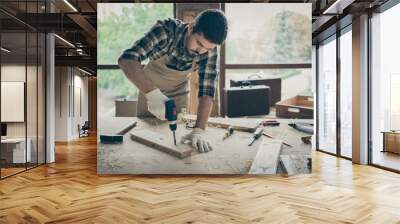 Portrait of his he nice attractive serious focused hardworking experienced guy repairman drilling creating new house building project order gift shop at modern industrial loft style interior Wall mural