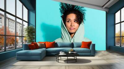 Portrait of minded girl wear hood head look interested empty space brainstorming isolated on turquoise color background Wall mural